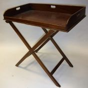 A mahogany butler's tray on folding stand in the George III manner