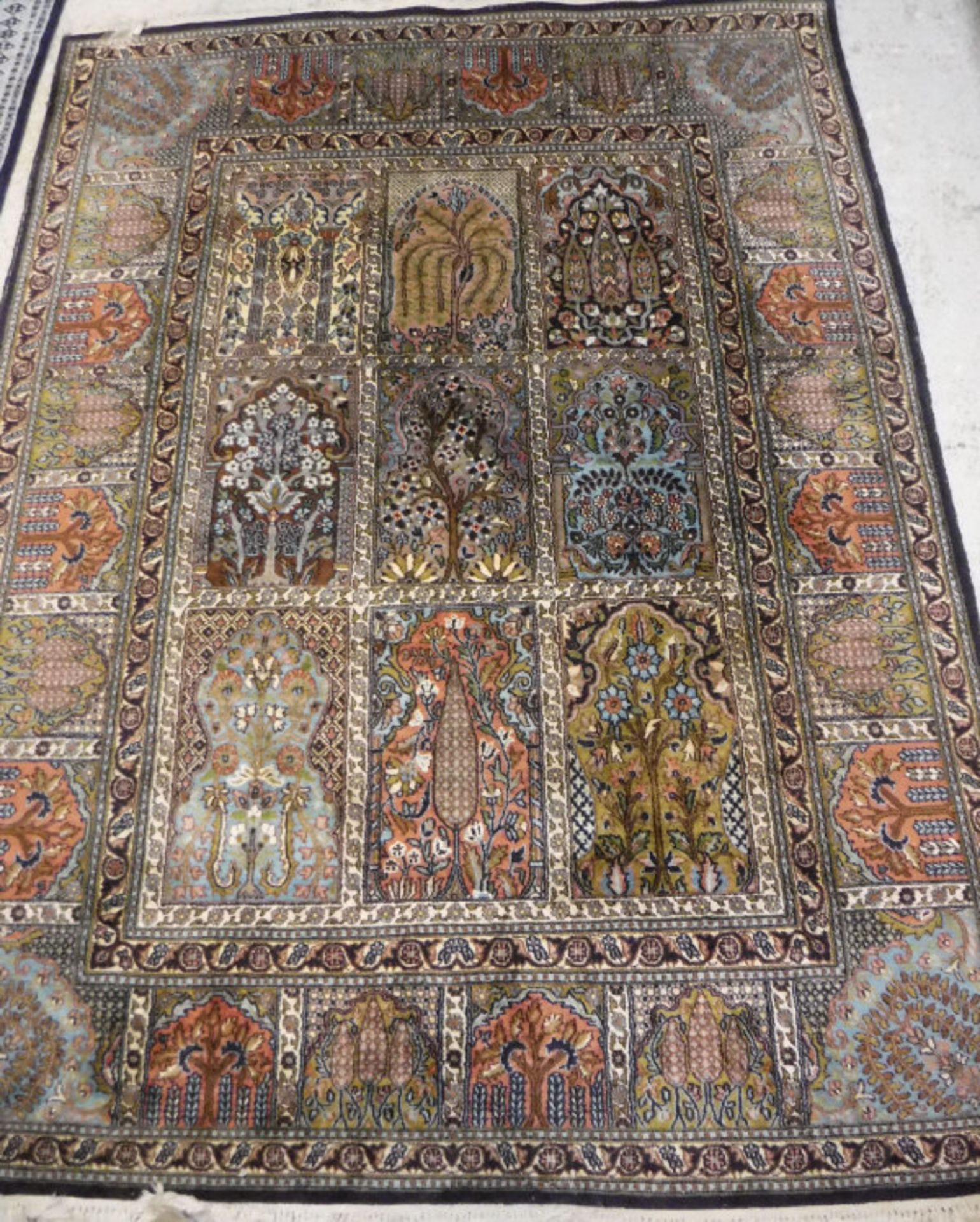 A Persian carpet, the central panel set with tiled pattern, each tile set with a floral design, - Image 2 of 2