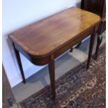 An early 19th Century mahogany and cross-banded fold-over card table of rounded rectangular form,
