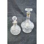 A cut glass decanter with silver mounts,