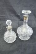 A cut glass decanter with silver mounts,