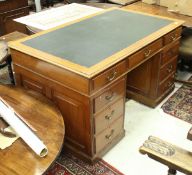 An early 20th Century mahogany kneehole double pedestal desk