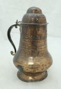 A 19th Century middle eastern copper dredger of baluster form with iron handle