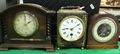 A 19th Century French ebonised cased mantel clock with circular enamelled dial and Roman numerals,