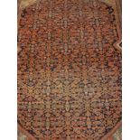 A fine Shenna rug, the central panel set with all over stylised floral decoration on a blue ground,