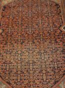 A fine Shenna rug, the central panel set with all over stylised floral decoration on a blue ground,