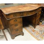 An early 20th Century mahogany pedestal desk of serpentine form in the George III manner,