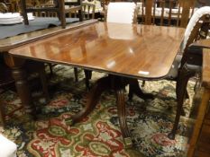 An early 19th Century mahogany tea table with rounded rectanglular snap top on a turned and reeded