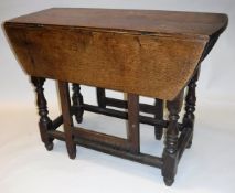 A 19th Century oak oval gate-leg drop leaf dining table with single end drawer on baluster turned