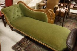 A Victorian chaise longue with walnut show frame and carved scrollwork decoration,