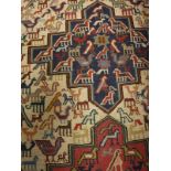 A Caucasian style rug, the central panel set with three medallions with stylised bird,