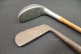 A Huntley putter with grooved handle together with another hickory shafted putter