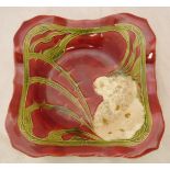 A Minton secessionist square dish decorated with a wild rose on a red ground and a glass