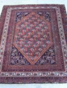 A Caucasian rug the central panel set with lozenge shaped medallion and repeating stylised hook