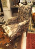 A circa 1900 floral upholstered armchair on cabriole legs to pad feet