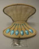 A cased set of six silver gilt and enamel decorated teaspoons,