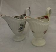 Two 18th Century Newhall porcelain cream jugs of helmet form,