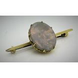 An opal set bar brooch, the opal of oval form with gold coloured mount, un-marked,