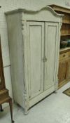 A Continental painted two door armoire,