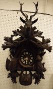 A Black Forest type carved cased cuckoo clock with Swiss musical movement playing "Lara's Theme"