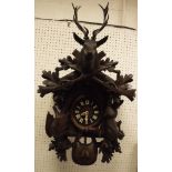 A Black Forest type carved cased cuckoo clock with Swiss musical movement playing "Lara's Theme"