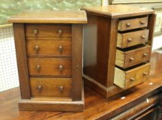 A pair of mahogany miniature Wellington type chests of four drawers on plinth bases,