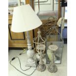 A painted wooden table lamp, together with two cast pricket-style candlesticks,