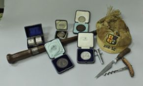 A box containing assorted sundry items to include a velvet school cap inscribed "1931-32" and bears