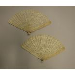 Two 19th Century ivory brisé fans depicting scenes of figures in a landscape with pagodas,