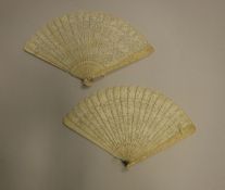 Two 19th Century ivory brisé fans depicting scenes of figures in a landscape with pagodas,