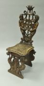 A 19th Century Continental carved walnut framed panel seated hall chair,