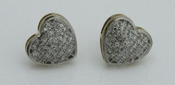 A pair of 9ct gold pave set diamond heart shaped ear studs