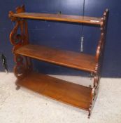 A circa 1900 mahogany three tier waterfall shelf unit on fretwork carved supports