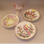 A pair of Sampson porcelain plates decorated with exotic birds, a Sampson figure of a chicken,