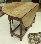 A oak drop leaf table together with four matching dining chairs with column shaped splat to green