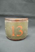 A painted brass mahogany mounted number "13" of curved form,