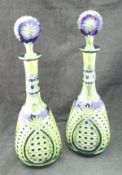 A pair of Bohemian blue overlaid glass decanters with hobnail and pineapple cut decoration,
