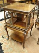 An Edwardian mahogany revolving bookcase on cabriole legs,