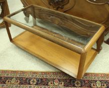 A 1970's G-Plan teak framed glass topped coffee table on castors,