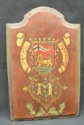 A painted armorial panel inscribed "Globus Concoedia" over the letter "M" with shield depicting