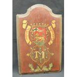 A painted armorial panel inscribed "Globus Concoedia" over the letter "M" with shield depicting