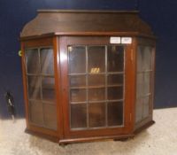 An Edwardian mahogany and leaded glazed wall cabinet