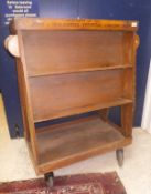 An early 20th Century oak book trolley or portable library inscribed "The property of St John and