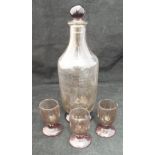 A 1920's Daum of Nancy smoky glass spirit carafe and stopper, together with three glasses,