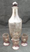 A 1920's Daum of Nancy smoky glass spirit carafe and stopper, together with three glasses,