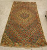 A Turkish brocade textile with diamond lattice decoration on a olive green ground with red,