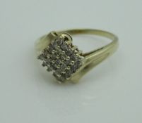A ladies 9ct yellow and white gold ring set with a central panel of twenty-five small diamonds,