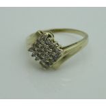 A ladies 9ct yellow and white gold ring set with a central panel of twenty-five small diamonds,
