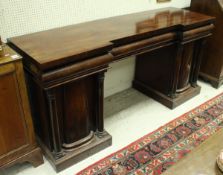 A Victorian mahogany breakfront double pedestal sideboard with three frieze drawers over two