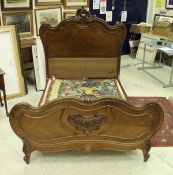 A mahogany framed double bedstead in the Louis XV taste with carved decorated ends on cabriole legs